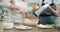 Hands of mothers and daughters prepare muffins, knead the dough with tart lemon zest, close up