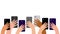 Hands of multicultural people with cell phones. Group of people men and women take photos, videos on smartphone. Record