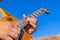 Hands of a musician close-up who plays an electric guitar in nature. Soft focus.