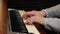 Hands of a musician a woman playing the piano keys