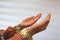 Hands of muslim people praying with mosque interior background.