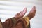 Hands of muslim people praying with mosque interior background.