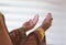 Hands of muslim people praying with mosque interior background.