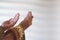 Hands of muslim people praying with mosque interior background.