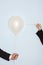 Hands With Needle And Balloon Against Blue Background