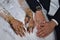 hands of the newlyweds together with wedding gold rings, drawing with oriental henna on the skin, not a tattoo