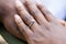 Hands of an nigerian couple. She is wearing an engagement ring