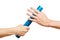 Hands offering relay baton during race