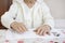 Hands of an old woman prepared for a cosmetic treatment.