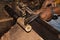 Hands of old worker forming a piece of bamboo wood with metal tool in a paper umbrella factory in Chiang Mai - Thailand