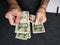 hands of an older man counting chinese banknotes