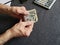 hands of an older man counting japanese banknotes