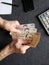 hands of an older man counting uruguayan banknotes