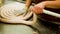 Hands of operators filling and forming sausages at food factory