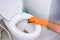Hands in Orange gloves cleaning WC, Toilet, lavatory