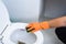 Hands in Orange gloves cleaning WC, Toilet, lavatory