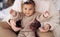 Hands of parents hold joyful mixed race baby girl