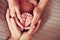 The hands of parents holding the feet of the baby. Wedding rings