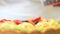 Hands pastry chef preparing a fruit tart