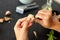 Hands peeling garlic with knife for pesto sauce