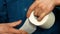 The hands of a pensioner hold a roll of toilet paper. An elderly man unwinds and tears off toilet paper. Digestive problems, const