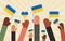 The hands of people of different nationalities in the struggle for peace in Ukraine hold flags with blue and yellow. Horizontal ba