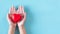 Hands people holding red heart model on blue backgroung,World heart day concept