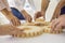 Hands of people office workers business partners making common picture of wooden gears