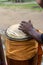 Hands of a percussionist playing atabaque at a religious event