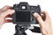 Hands photographer adjust digital SLR camera isolated