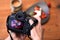 Hands of photographer holding dslr camera taking a photo of a strawberry dessert