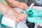 Hands of the physician of the podologist make pedicure close up