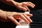 Hands of pianist play the keys of the piano on black background close up