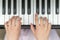 Hands on piano keys close-up. Closeup girl\'s hand playing piano. Favorite classical music. Top view with dark vignette. View from