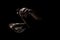 Hands  playing an old tibetan singing bowl. Black background. Music therapy