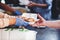 The hands of the poor handed a plate to receive food from volunteers to alleviate hunger, the concept of helping the homeless