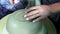 Hands of a potter, creating a bowl using a die, ceramic polishing process