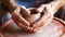 hands of a potter, creating an earthen jar