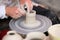 Hands of a potter creating vases