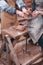 The hands of potter help make pitcher on pottery wheel