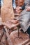 The hands of potter help make pitcher on pottery wheel