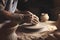 Hands of a potter making a clay pot in close-up