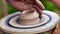 Hands of a potter working with clay