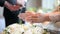 Hands pouring blessing water into groom and bride bands, Thai wedding