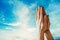 Hands praying on blurred of blue sky backgrounds. Faith in Jesus Christ. Christianity. Church worship, salvation concept