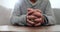 Hands, praying and closeup for faith, home and gratitude with peace, mindfulness and religion on table. Person, prayer