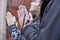 Hands of a praying couple holding prayer beads