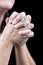 Hands praying and holding a small crucifix