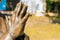 The hands of a praying Tibetan monk or Christian priest, an element of a bronze monument. Background, selective focus