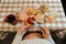 Hands of a pregnant Latina woman spreading strawberry jam on toast during breakfast. Copy space